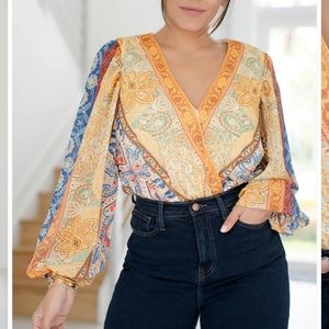 Deep v neck shirt with loose long sleeves.